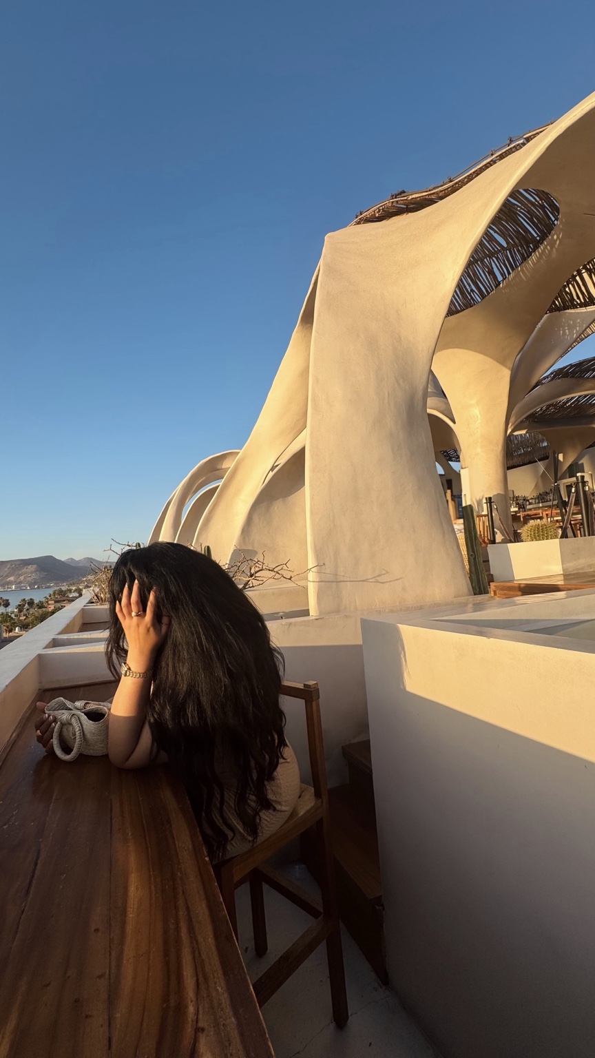 Jennifer enjoying golden hour at a sculptural coastal resort