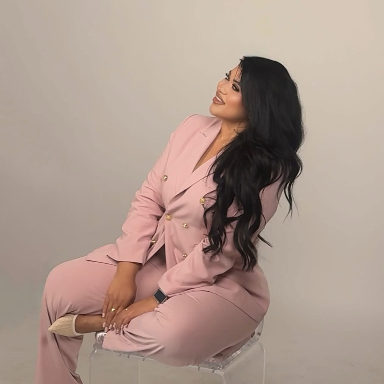 Jennifer Estrada, creator of LifewJaycie, wearing a soft pink suit