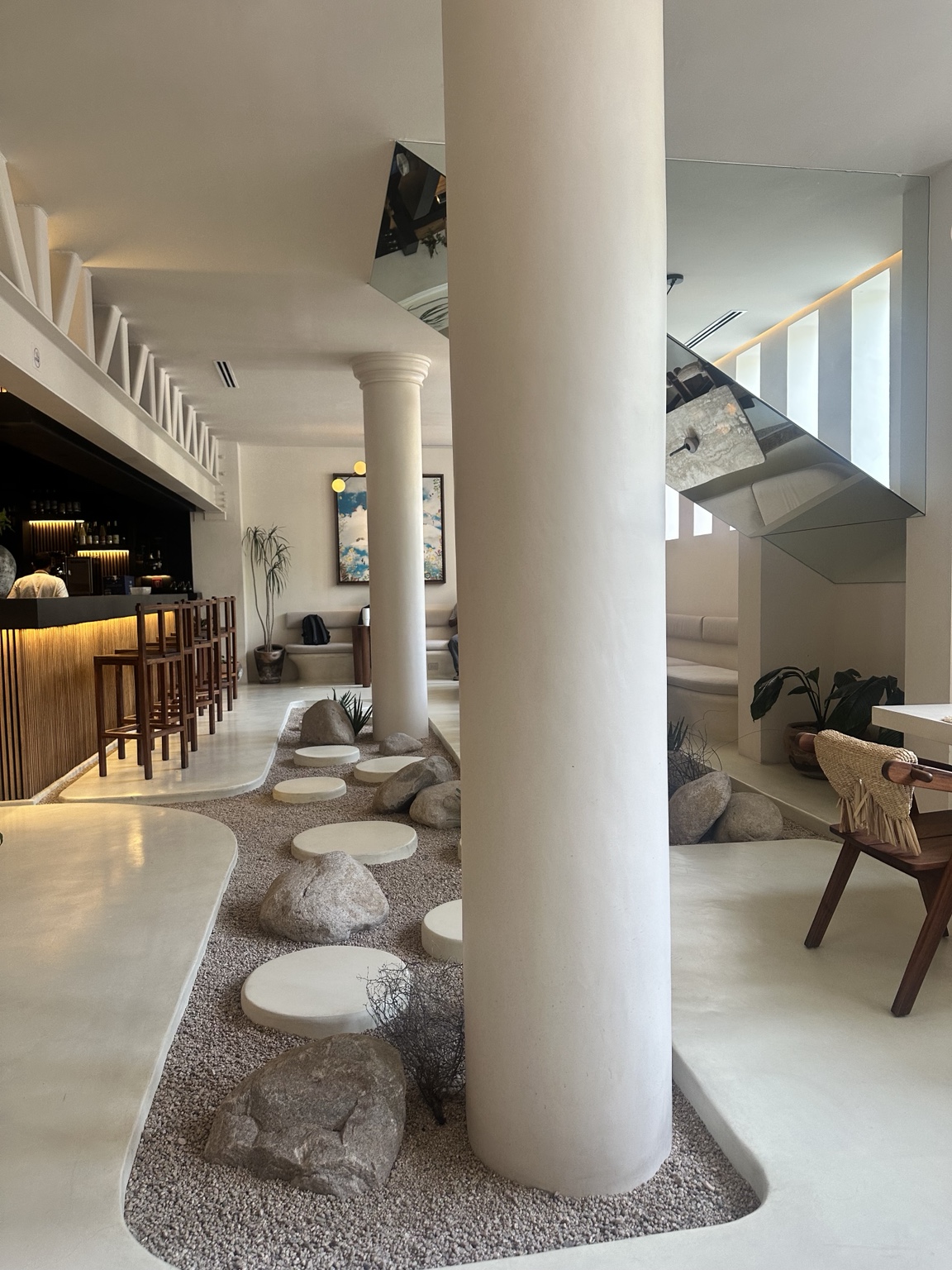 A serene hospitality interior with a Japandi rock garden